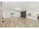 Open-concept living room with hardwood floors, recessed lighting, and modern finishes that leads to kitchen at 2554 Lake Ellen Cir, Tampa, FL 33618
