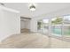 Bright room with hardwood floors and sliding glass doors to a pool at 2554 Lake Ellen Cir, Tampa, FL 33618