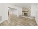 Inviting living room featuring a stone fireplace and wood-look flooring at 2554 Lake Ellen Cir, Tampa, FL 33618