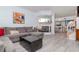 Open-concept living room with a decorative fireplace and views into the kitchen and dining area at 2648 Sabal Springs Dr # 2, Clearwater, FL 33761