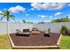 Private backyard with a cozy fire pit and seating area at 2708 Dolphin Watch Ct, Holiday, FL 34691
