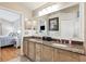 Bathroom displays the double sink vanity with granite countertops and an expansive mirror at 2708 Dolphin Watch Ct, Holiday, FL 34691
