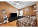 Bedroom features wood floors, ceiling fan, and tv on a dresser at 2708 Dolphin Watch Ct, Holiday, FL 34691
