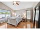 Bright bedroom with hardwood floors, ceiling fan, and large windows at 2708 Dolphin Watch Ct, Holiday, FL 34691