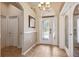 Inviting foyer with decorative glass front door, tiled flooring, and access to additional rooms at 2708 Dolphin Watch Ct, Holiday, FL 34691