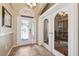 Bright and airy foyer with decorative glass doors and tiled flooring, offering a welcoming entrance at 2708 Dolphin Watch Ct, Holiday, FL 34691