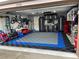 Organized garage with workspace, modular floor tiles, and storage solutions for a functional and tidy space at 2708 Dolphin Watch Ct, Holiday, FL 34691