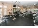 Well-equipped gym with weight machines, free weights, and TV at 2708 Dolphin Watch Ct, Holiday, FL 34691