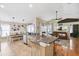 Open-concept kitchen island with stainless appliances, granite countertops, and seating area that overlooks the living area at 2708 Dolphin Watch Ct, Holiday, FL 34691