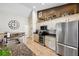 Charming kitchen featuring granite countertops, stainless steel appliances, tile floors, and lots of storage at 2708 Dolphin Watch Ct, Holiday, FL 34691