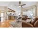 Open concept living room and kitchen with bar stool seating, hardwood floors, and comfortable seating at 2708 Dolphin Watch Ct, Holiday, FL 34691
