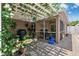 Lush outdoor patio with seating area and views of the landscaped yard at 2708 Dolphin Watch Ct, Holiday, FL 34691