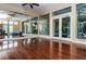 Bright yoga studio with hardwood floors, mirrored walls, and natural light at 2708 Dolphin Watch Ct, Holiday, FL 34691