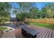 Private backyard with a modern fire pit, wood deck, and lush landscaping at 300 33Rd N Ave, St Petersburg, FL 33704