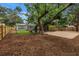Wide backyard featuring a patio, home, mature trees, and a wooden fence at 300 33Rd N Ave, St Petersburg, FL 33704