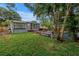 Backyard view with the home, wooden deck, patio, furniture, and a well-maintained lawn at 300 33Rd N Ave, St Petersburg, FL 33704