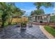 Backyard patio with outdoor seating, a well-maintained lawn, and a wooden deck at 300 33Rd N Ave, St Petersburg, FL 33704