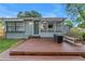 Backyard deck features a fire pit, bench seating, and access to the home's interior at 300 33Rd N Ave, St Petersburg, FL 33704