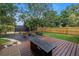 Well-maintained backyard with a wooden deck, patio, outdoor furniture, and a privacy fence at 300 33Rd N Ave, St Petersburg, FL 33704