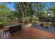 Backyard area with patio, outdoor seating, fire table, and a wooden deck at 300 33Rd N Ave, St Petersburg, FL 33704