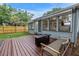 Exterior showcasing a wood deck, fire pit, and view into the living area through windows at 300 33Rd N Ave, St Petersburg, FL 33704