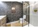 Bathroom showcasing a glass-enclosed shower, modern toilet, and eye-catching wallpaper at 300 33Rd N Ave, St Petersburg, FL 33704