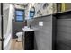 Charming bathroom featuring wood paneling, stylish wallpaper, and modern fixtures at 300 33Rd N Ave, St Petersburg, FL 33704