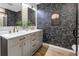 Modern bathroom with a dual sink vanity, stylish wallpaper, and framed mirrors at 300 33Rd N Ave, St Petersburg, FL 33704