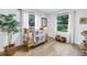 Bedroom with wood-look floors, a crib with animal-themed bedding, and plenty of natural light at 300 33Rd N Ave, St Petersburg, FL 33704