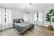 Bright bedroom featuring a modern chandelier, neutral walls, and wood-look floors at 300 33Rd N Ave, St Petersburg, FL 33704