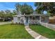 A charming home with a picket fence and colorful front flower garden at 300 33Rd N Ave, St Petersburg, FL 33704