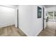 Bright hallway featuring wood-look floors, white walls, and doors to adjacent rooms at 300 33Rd N Ave, St Petersburg, FL 33704