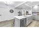 Bright kitchen featuring stainless appliances, an island with seating, and views into the adjacent living space at 300 33Rd N Ave, St Petersburg, FL 33704