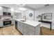 Kitchen featuring an island with a stainless sink, range, and modern stainless appliances in a well-lit area at 300 33Rd N Ave, St Petersburg, FL 33704