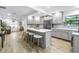 Open kitchen with gray cabinets, stainless steel appliances, white countertops, and a large island with seating at 300 33Rd N Ave, St Petersburg, FL 33704