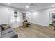 Bright living room featuring light wood floors, neutral colors, and lots of natural light from the large window at 300 33Rd N Ave, St Petersburg, FL 33704