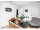 Cozy office features a modern desk, stylish accent chair, and a decorative 