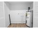 Utility room featuring a water heater, white walls, and wood flooring at 300 33Rd N Ave, St Petersburg, FL 33704