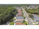 A high angle view of a quiet residential street and neighborhood nestled within lush green forests at 30918 Burleigh Dr, Wesley Chapel, FL 33543