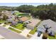 Aerial view of several homes showcasing lush landscaping, a scenic pond, and neighborhood layout at 30918 Burleigh Dr, Wesley Chapel, FL 33543