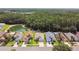 Aerial view of a neighborhood with mature trees and a pond adding to the scenic landscape at 30918 Burleigh Dr, Wesley Chapel, FL 33543