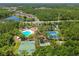 An aerial view of community amenities, including a pool, tennis courts, and basketball courts at 30918 Burleigh Dr, Wesley Chapel, FL 33543