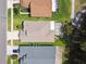 Overhead view of home displaying roof and yard, including a screened in patio and tidy landscaping at 30918 Burleigh Dr, Wesley Chapel, FL 33543