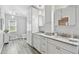 Bright bathroom with double sink vanity, granite countertops, stylish mirror cabinets, and a toilet at 30918 Burleigh Dr, Wesley Chapel, FL 33543