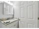 Bright bathroom featuring a granite countertop, a modern sink, and a vanity with ample storage space at 30918 Burleigh Dr, Wesley Chapel, FL 33543