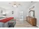 Spacious bedroom with a ceiling fan, ensuite access, and wood-look floors at 30918 Burleigh Dr, Wesley Chapel, FL 33543
