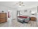 Comfortable bedroom with wood-look flooring and a window that provides natural light at 30918 Burleigh Dr, Wesley Chapel, FL 33543