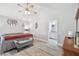 Spacious bedroom with ensuite access, ceiling fan, and modern light-grey floors at 30918 Burleigh Dr, Wesley Chapel, FL 33543