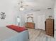 Bright and airy bedroom featuring hardwood-style floors and an ensuite bath at 30918 Burleigh Dr, Wesley Chapel, FL 33543
