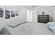 Comfortable bedroom with a queen bed, dresser, closet and nautical themed decor at 30918 Burleigh Dr, Wesley Chapel, FL 33543